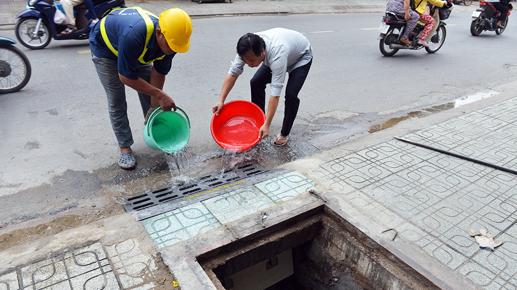 Water is poured into the newly installed sewer openings to test the pressure-controlled valves. Photo: Tuoi Tre