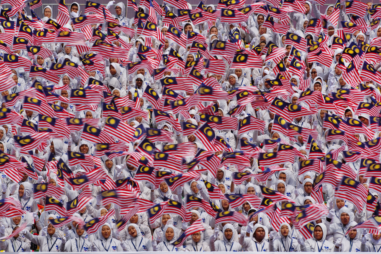 Hundreds of Malaysian flags are waved by the country’s citizens during a celebration. Photo: Tan Ee Long