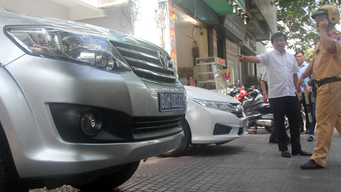 Doan Ngoc Hai asks a traffic police officer to handle a state-owned car for illegal parking in Ho Chi Minh City.