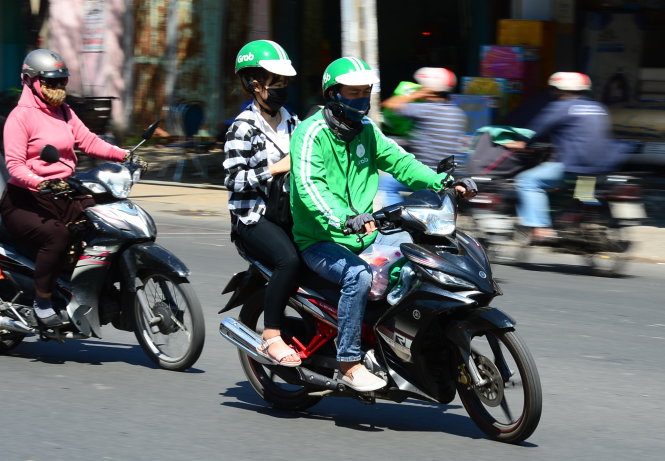 A GrabBike and his customer are seen in Ho Chi Minh City.