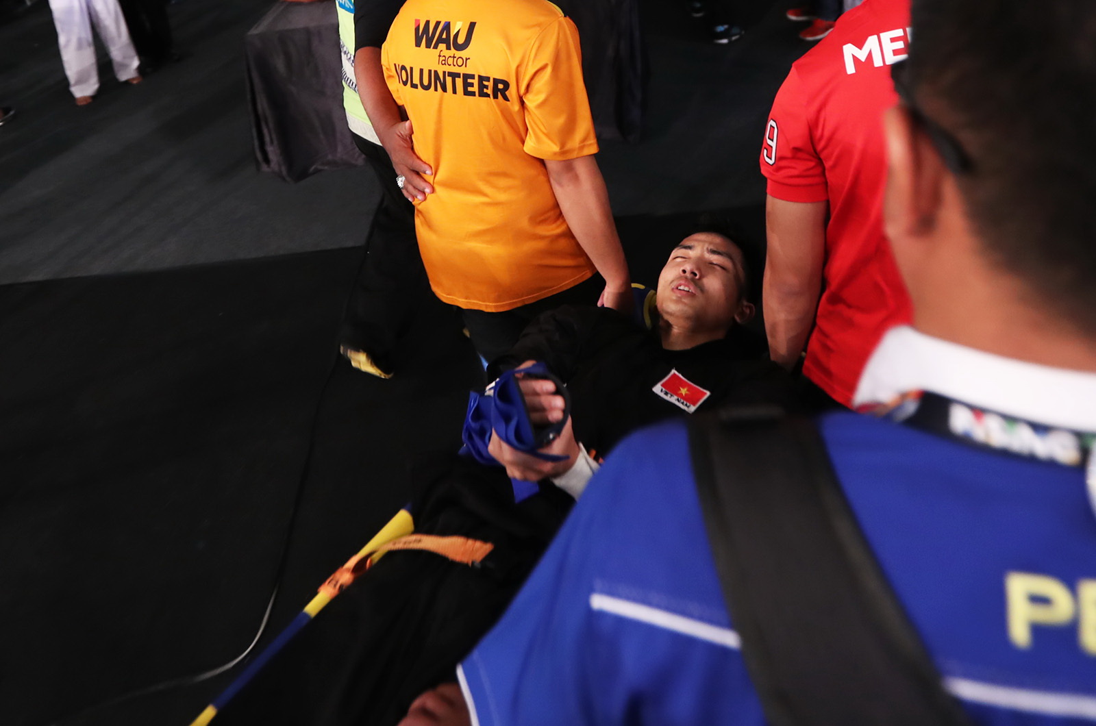Vietnam's Pham Tuan Anh is taken to hospital with his broken arm.