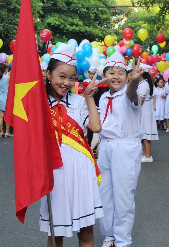 Two students in Ha Tinh Province smile for a photo while attending their school’s opening ceremony for the 2017-2018 academic year, September 5, 2017. Photo: Tuoi Tre