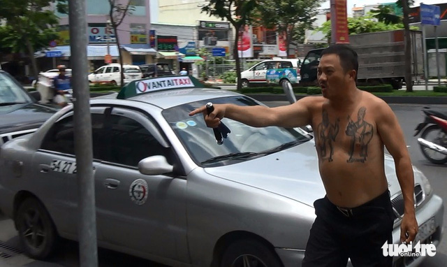 Phuc takes off his shirt and pulls out his paper knife.