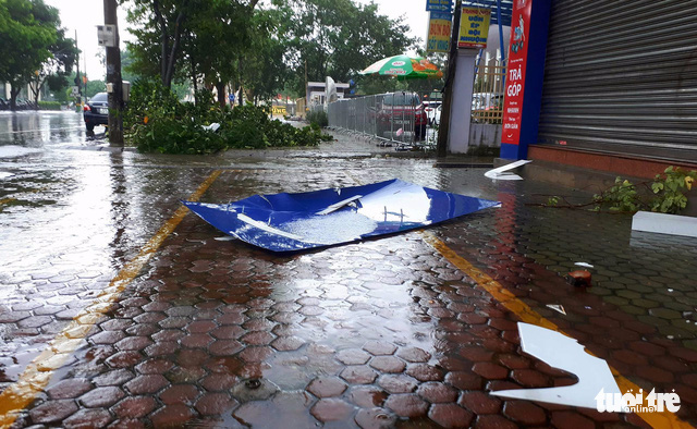 Street signs and trees branches are blown away by the storm in Vinh City, Nghe An Province.