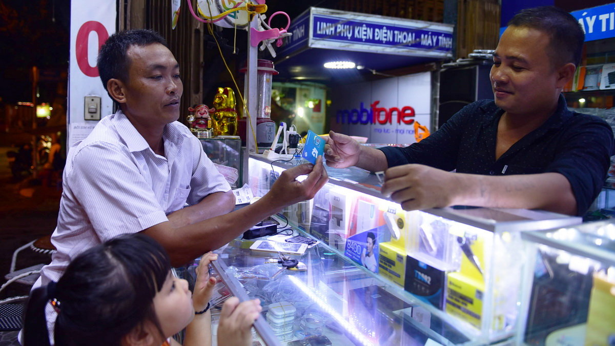 A man chooses SIM card at a store in Ho Chi Minh City.