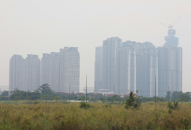 Under-construction buildings are seen being blanketed with smog.