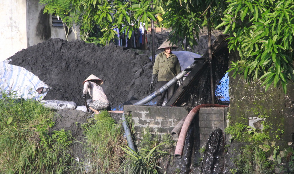 Coal pieces are collected and filtered to be sold for profit. Photo: Tuoi Tre