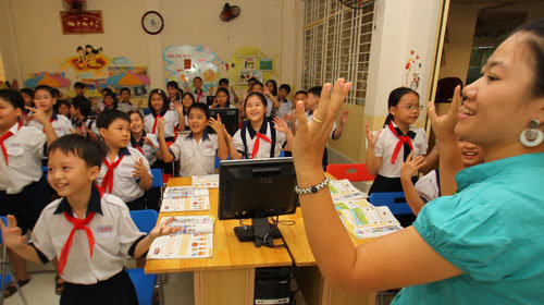 A native English teacher and her students are pictured in a class in Ho Chi Minh City.