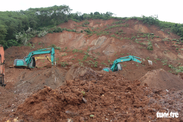 Excavators remove rocks and soil after a landslide at Lam Giang Train Station in the northern province of Yen Bai.