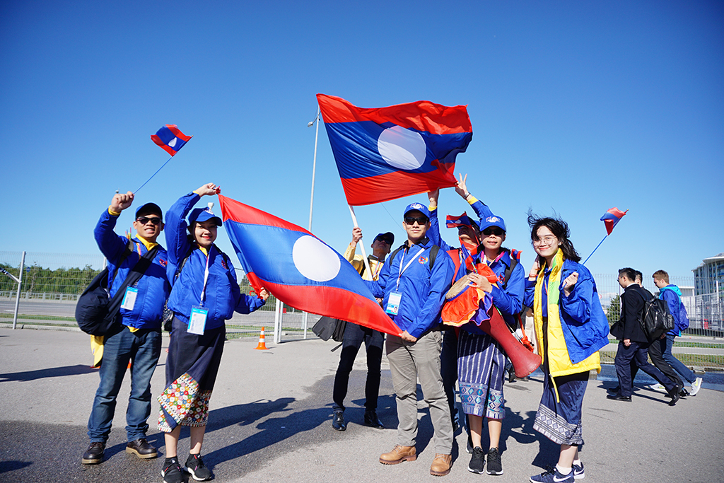 Delegates from Laos raise their national flags.