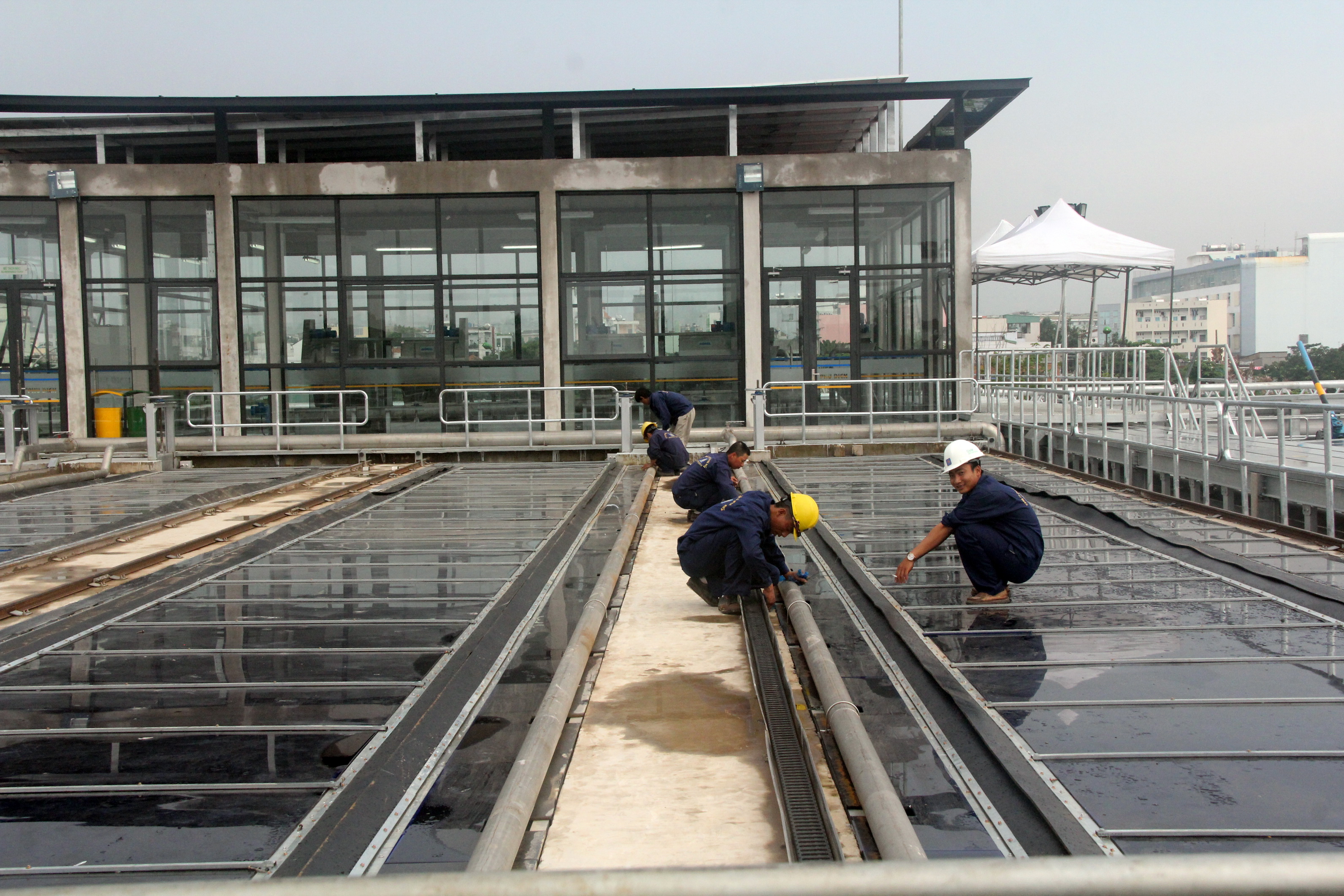 Employees examine the wastewater treatment process at the facility. Photo: Tuoi Tre