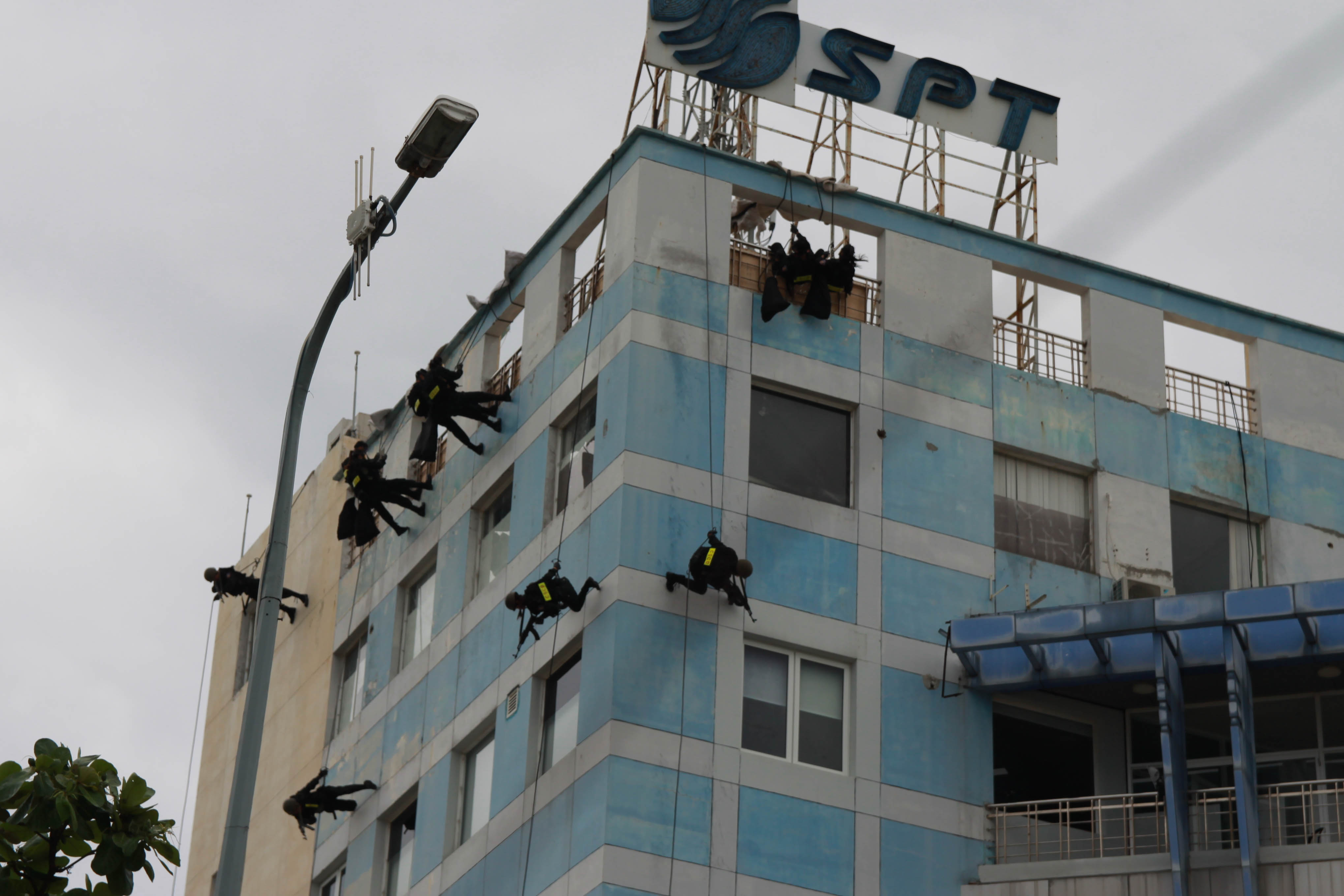 Officers enter the building from the rooftop.