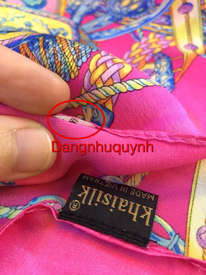 The sign (in red circle) suggesting that the 'Made in China' had been cut out is seen on a Khaisilk handkerchief in this photo on the Facebook of Dang Nhu Quynh