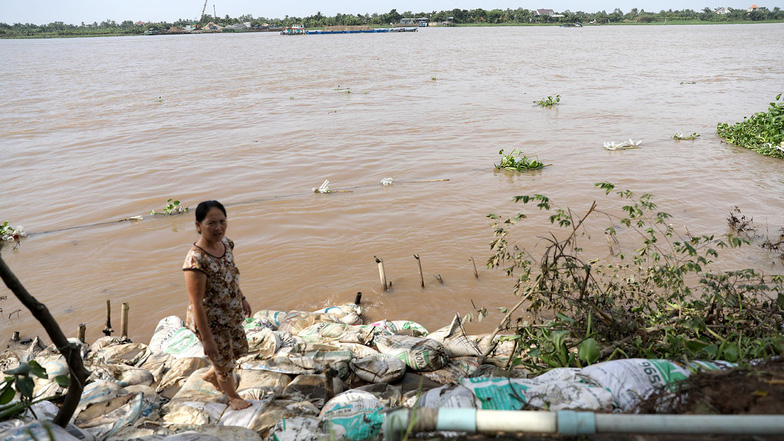A Tan Phong Islet resident stands where her previous house was sunk by subsidence. Photo: Tuoi Tre