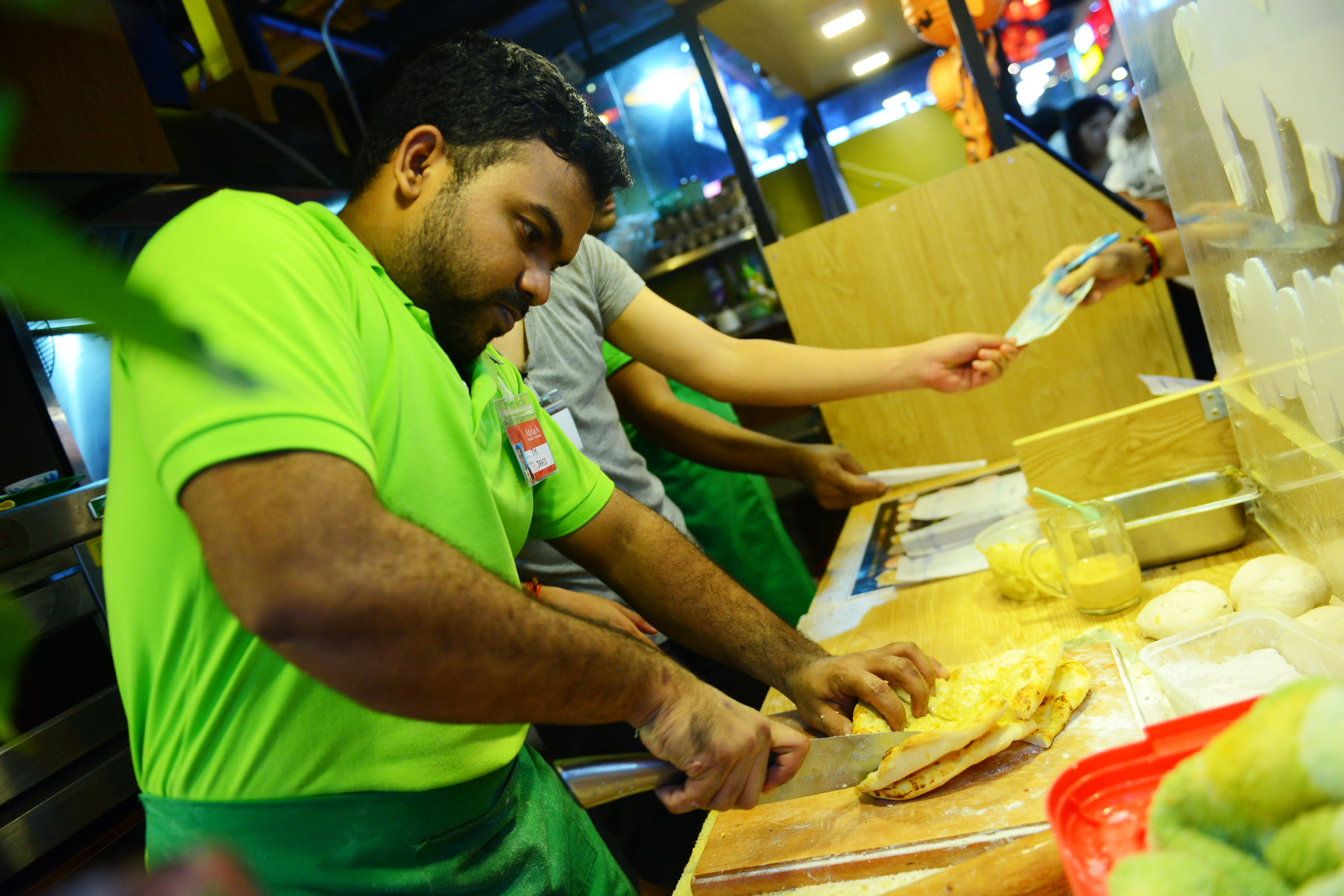 Jahid, an Indian chef, makes Naan, a popular Indian dish at the Asiana Food Town.