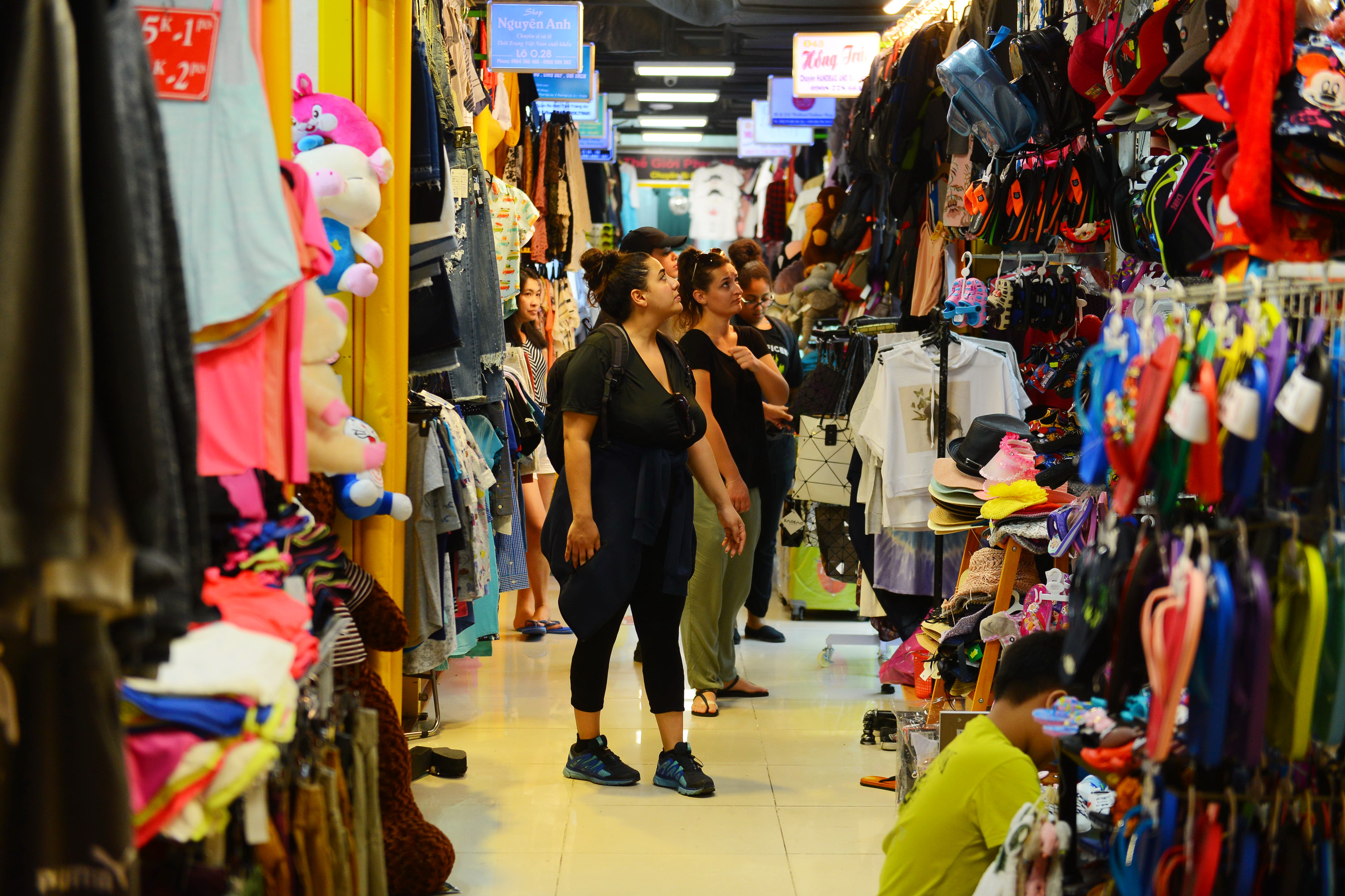 Foreign tourists browse for clothes at the Sense Market Shopping Center.