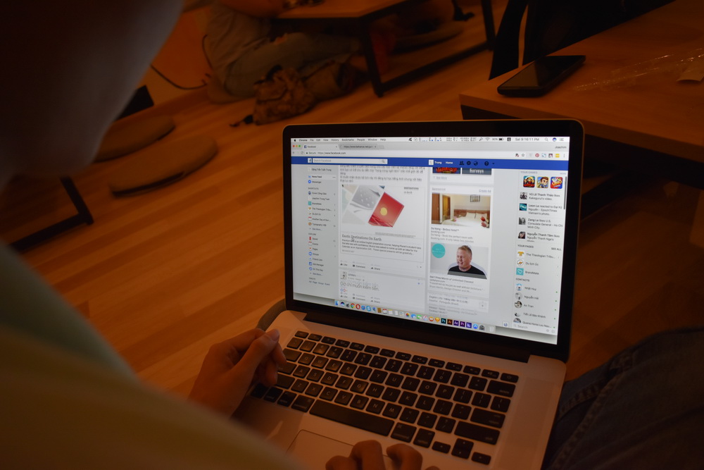 A Vietnamese man uses Facebook on his laptop. Photo: Tuoi Tre News
