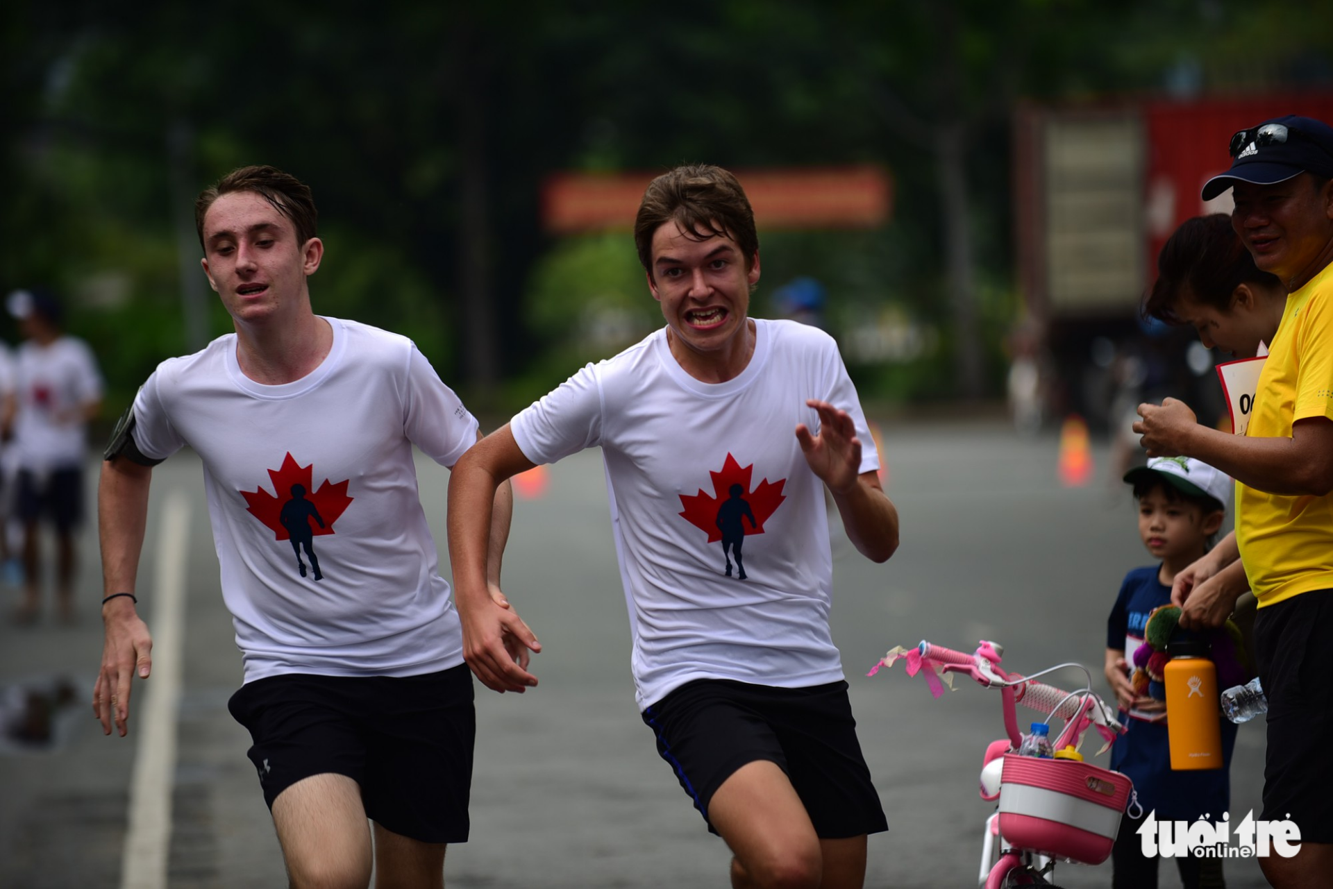 Two foreign runners sprint towards the finish line.
