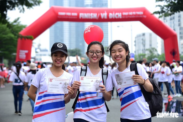 A group of university students receive certificates after completing the charity run.