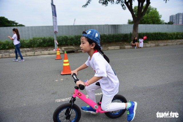 A young girl cycles at the charity run.
