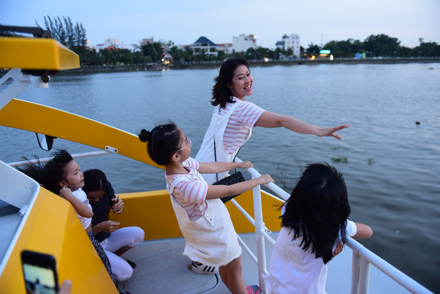Passengers, particularly kids, delight at the breezy journey. Photo: Tuoi Tre