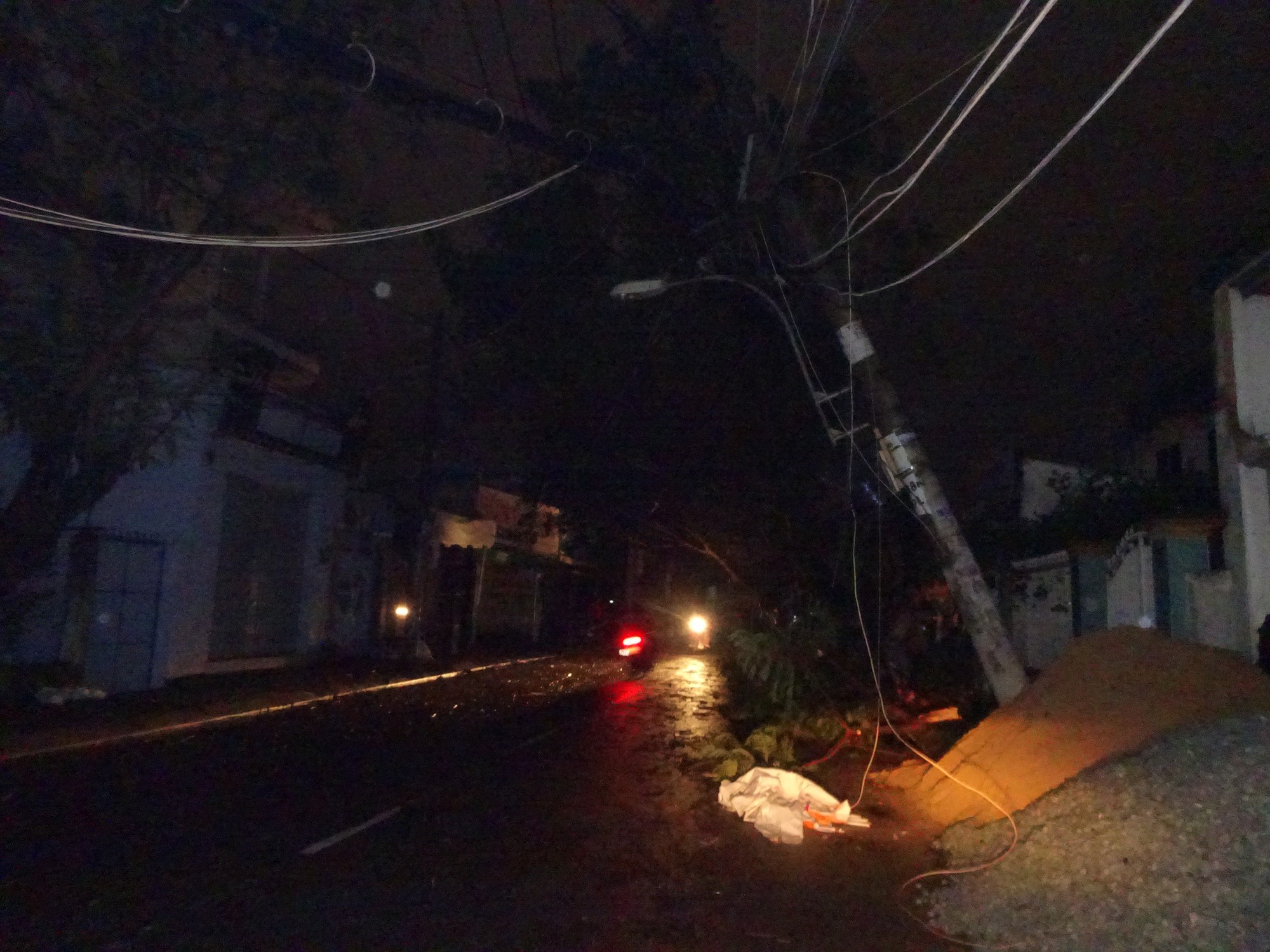 A utility pole falls over following heavy rains. Photo: Tuoi Tre