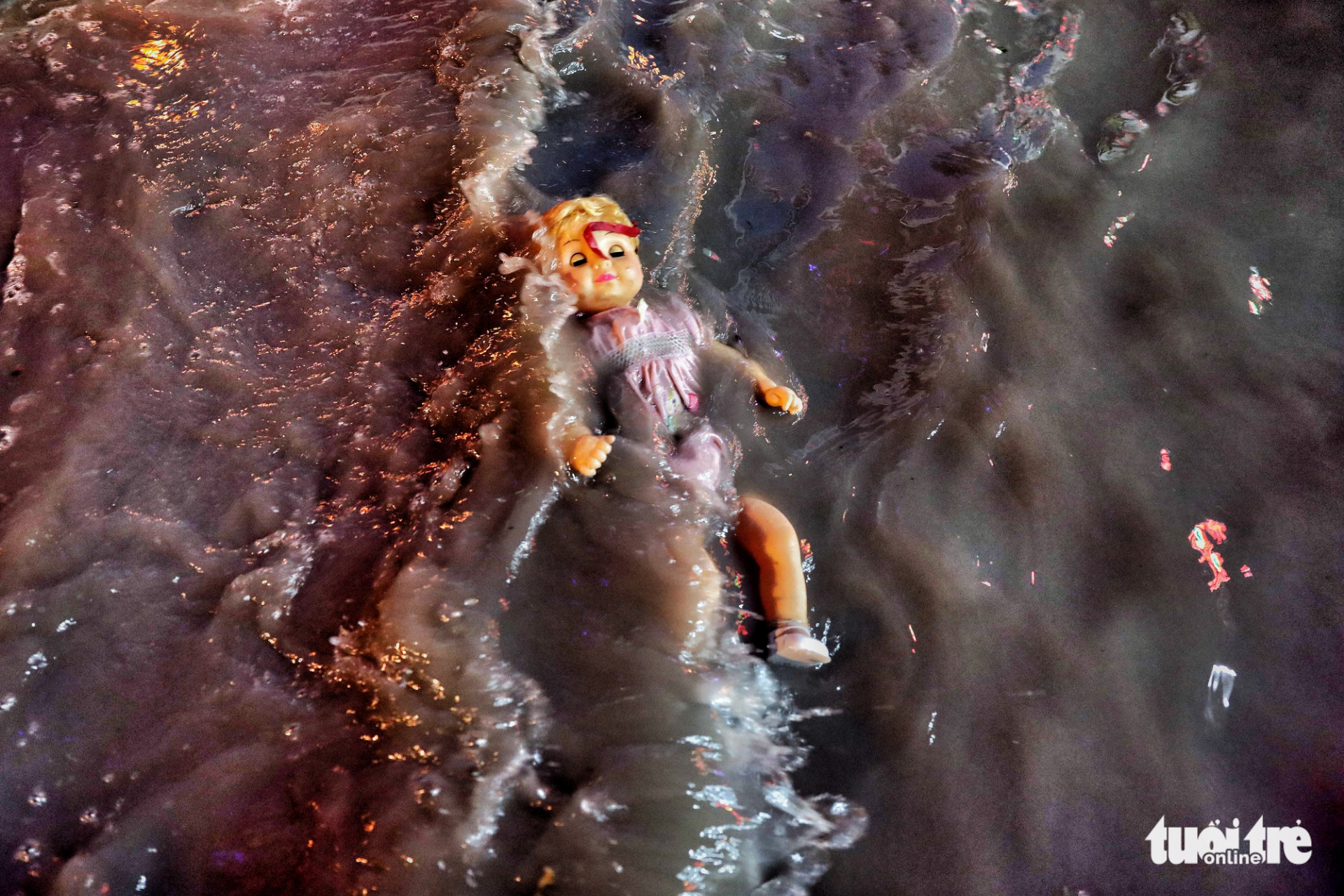 A doll floats in floodwaters. Photo: Tuoi Tre