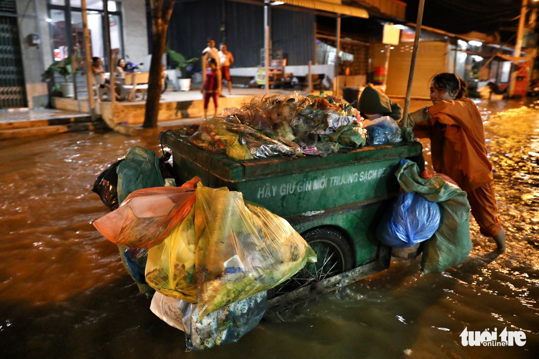 A garbage collector struggles to work through the floods.