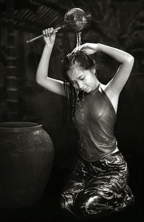 The alluring charm of a girl washing her hair is accentuated in a photo by Duong Quoc Dinh.