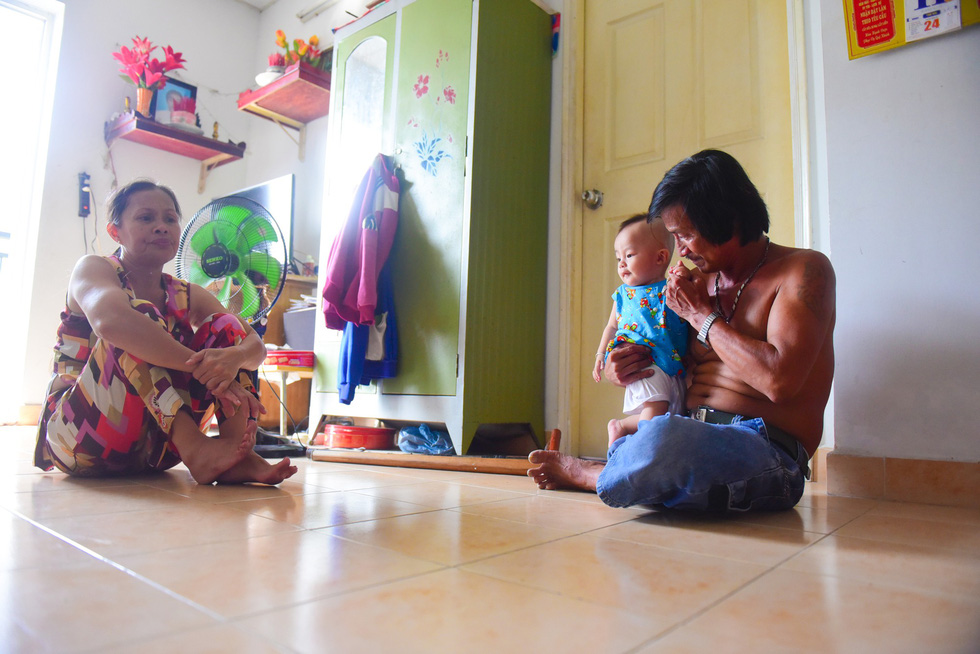 The family of Ta Thi Gai (L), one of the relocated households, is still unable to pay their debt on flat.
