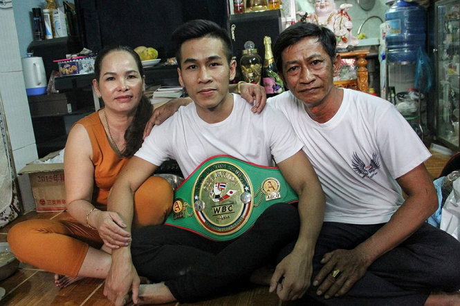 Tran Van Thao holding his WBC Asia belt surrounded by family. Photo: Thao's Facebook Page