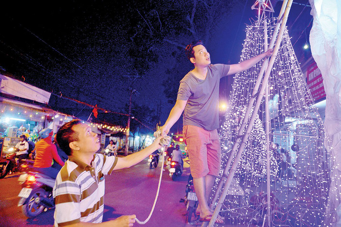 Local residents hang up the lights for their Christmas cavern.