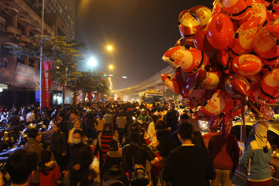 People walk toward the Vincom Mega Mall Royal City for Christmas celebration.