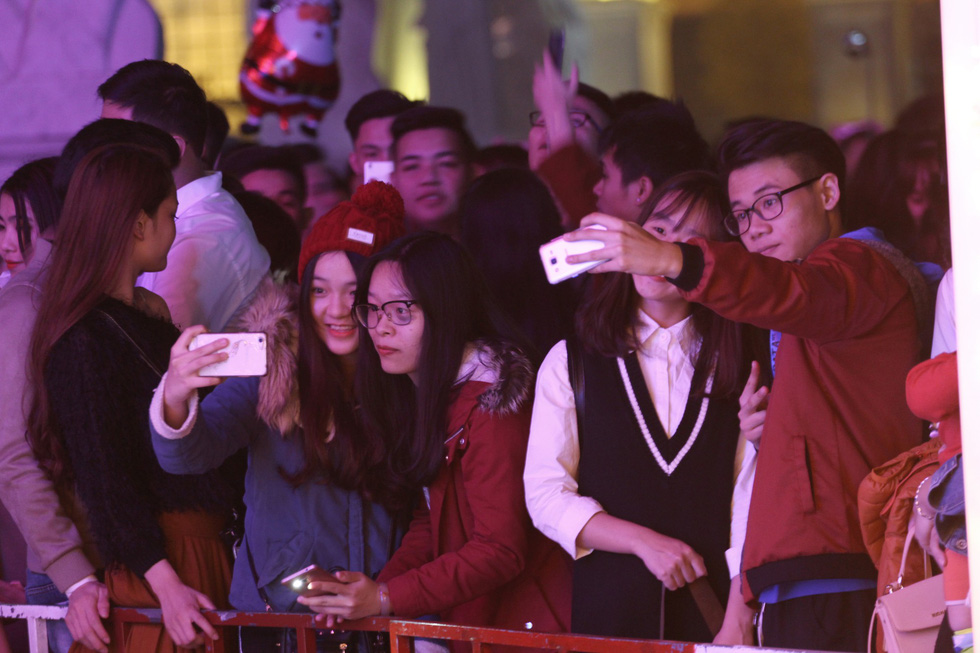 Young people take a selfie on Christmas Eve in Hanoi.