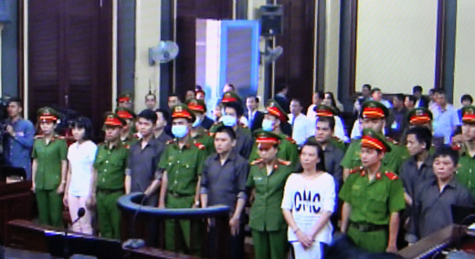 Pham Lisa (white shirt) and other defendants are seen at a court in Ho Chi Minh City in this photo taken from a TV screen. Photo: Tuoi Tre