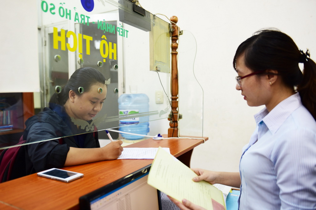 A public servant is seen at her office in Ho Chi Minh City. Photo: Tuoi Tre