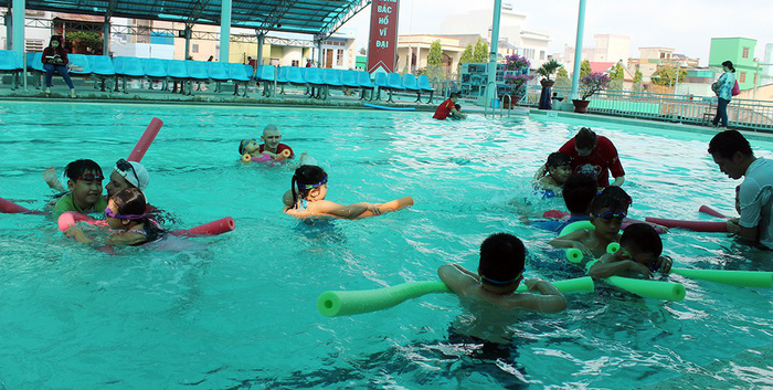 Local children learn how to swim during a lesson. Photo: Tuoi Tre
