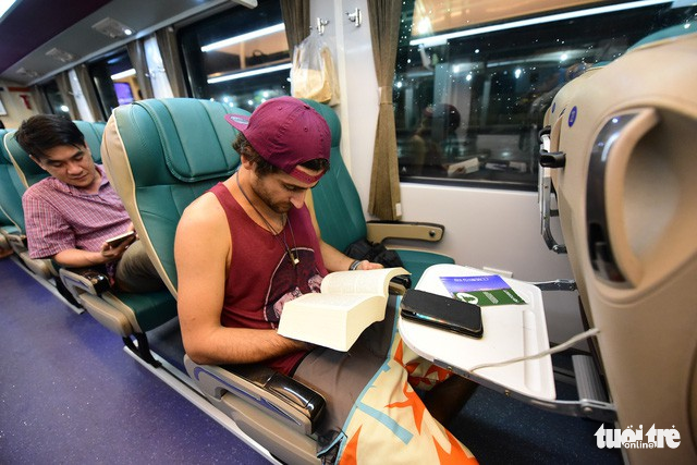 A foreign passenger reads his book on the new SE4 train.