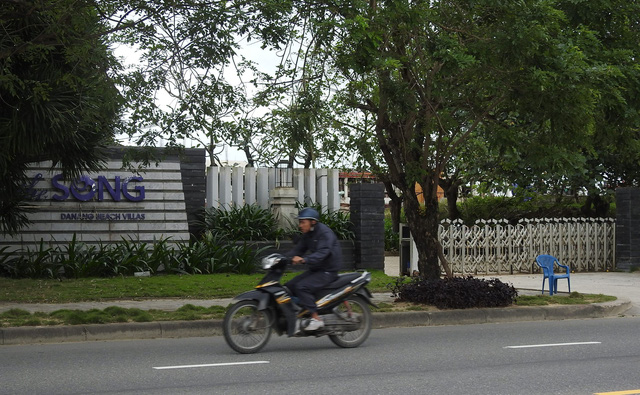 A man rides past the entrance to the The Song resort project in Ngu Hanh Son District, Da Nang. Photo: Tuoi Tre