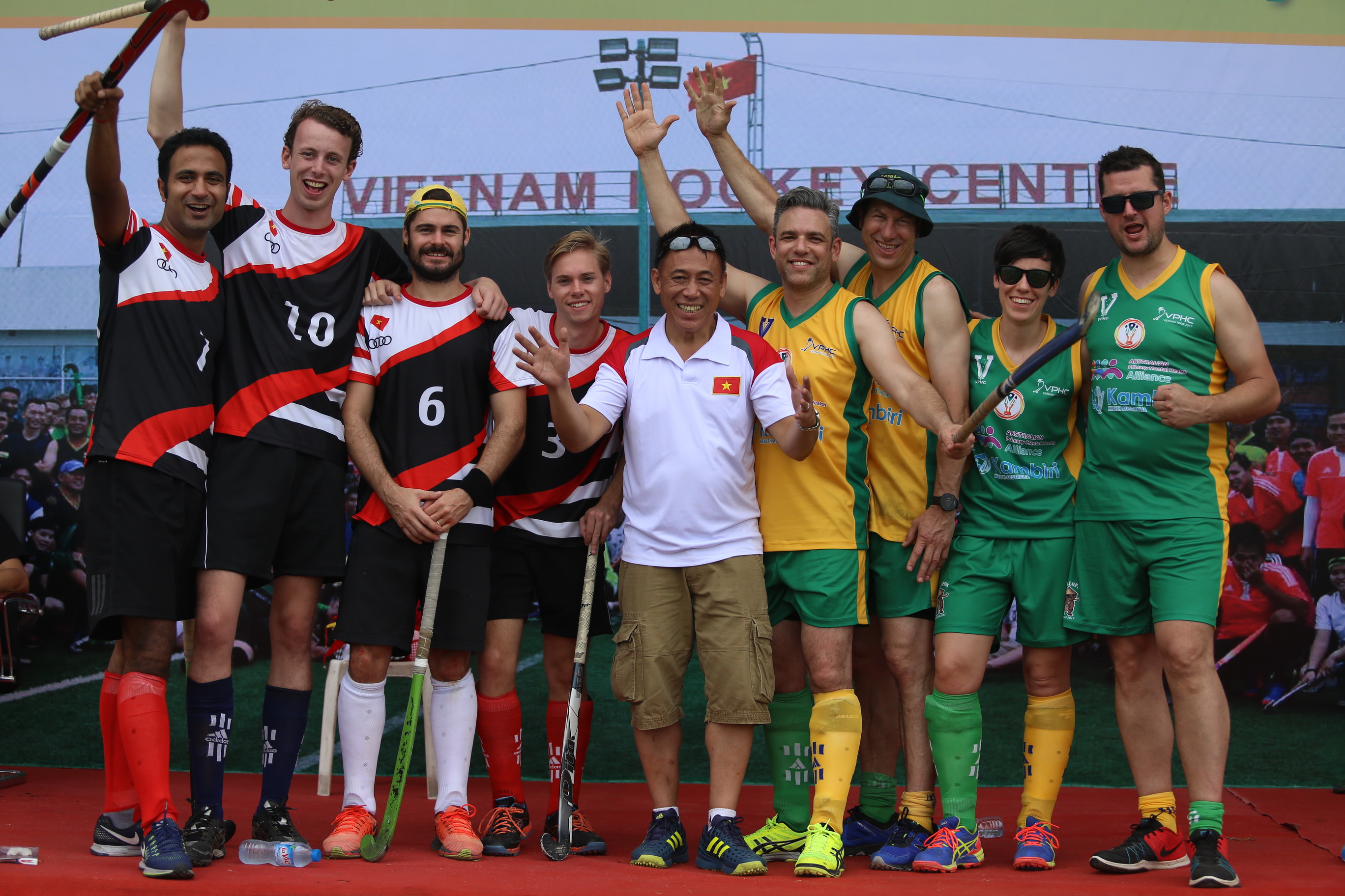 James Chew (fifth from the left) posing with hockey players