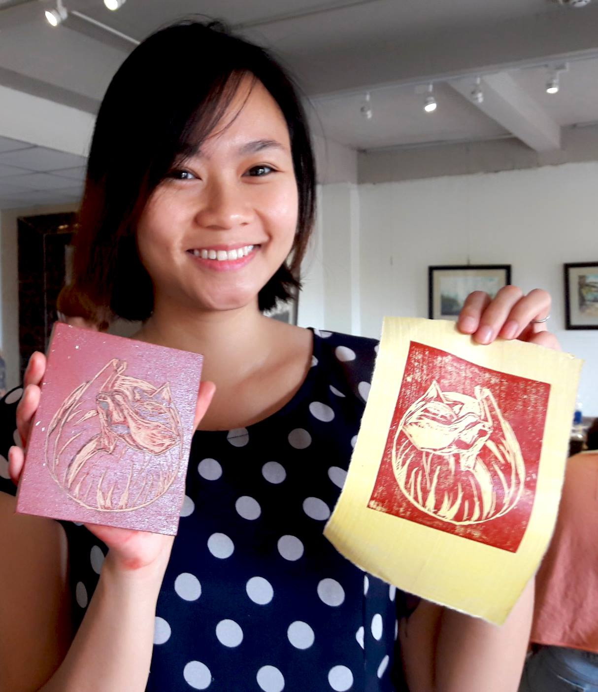 A participant of one of Jack Clayton’s woodcut printmaking workshops displays her work. Photo: Supplied by the artist