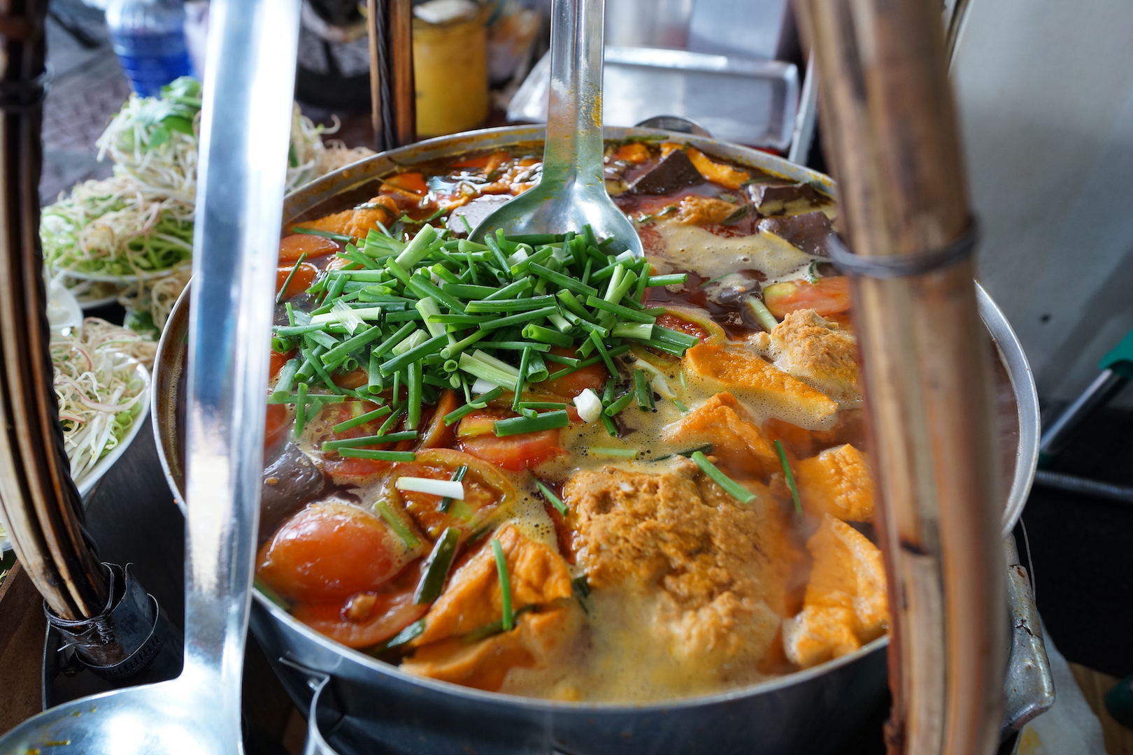 The broth at Bun Rieu Ganh with tofu, crabmeat, tomatoes and many other ingredients, taken on January 23, 2018. Photo: Tien Bui