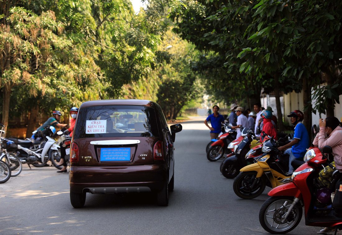 Tam performs a test run on his electric automobile near his house in Cu Chi District, Ho Chi Minh City.