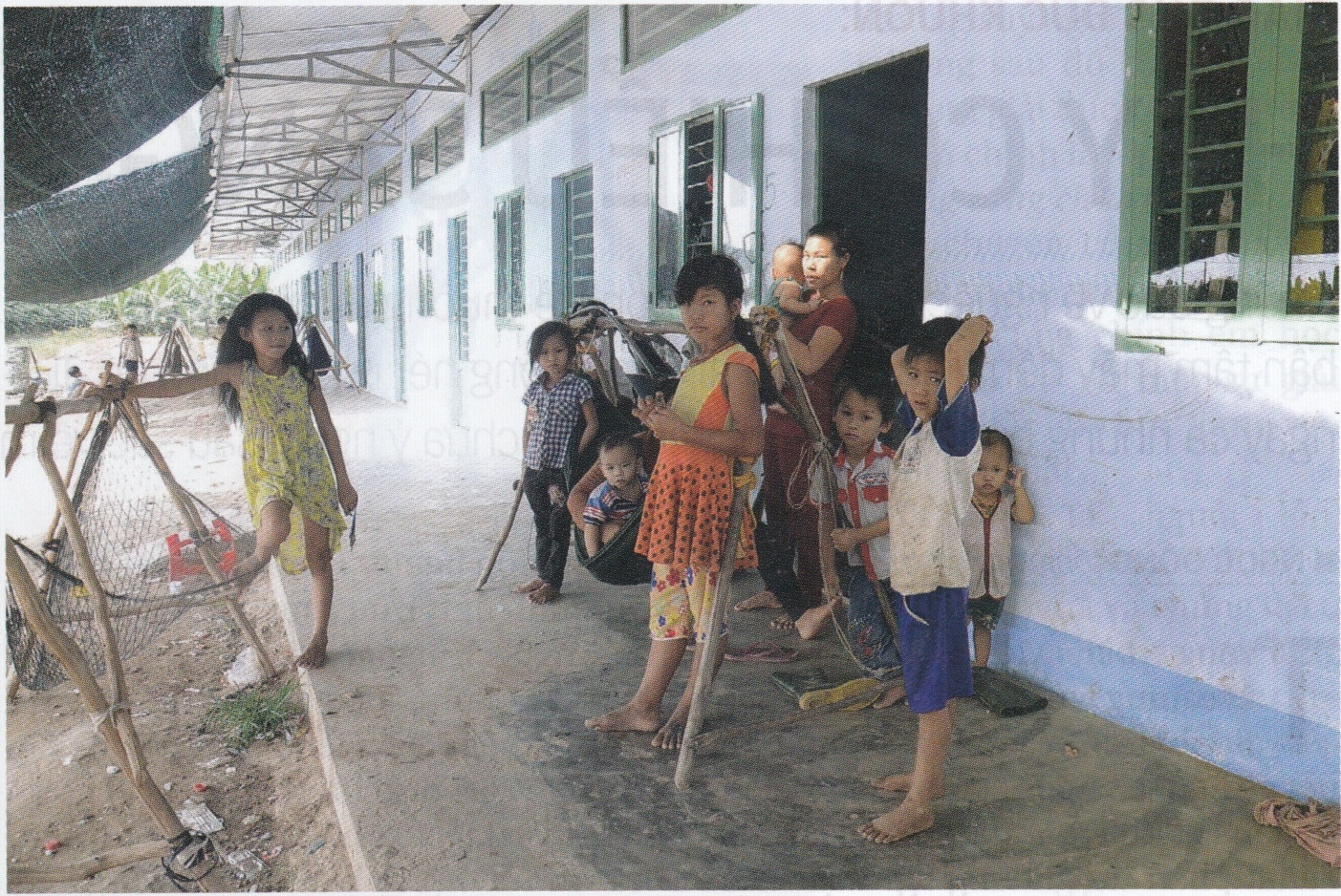 Kids frolic outside a block of workers' houses at the farm. Photo: Tuoi Tre