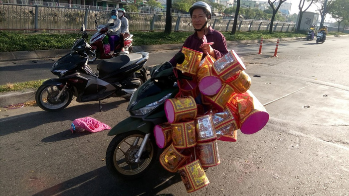 A man carries joss paper items on Vo Van Kiet Street, in District 5, Ho Chi Minh City. Photo: Tuoi Tre