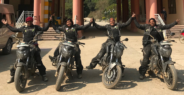The bikers pose for a photo at the Na Meo border gate. Photo: Tuoi Tre