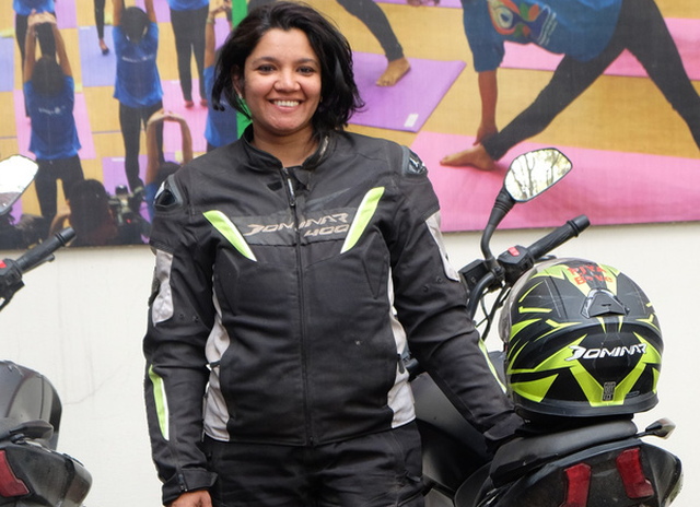Piya Bahadur, from the quartet, stands by her motorbike. Photo: Tuoi Tre