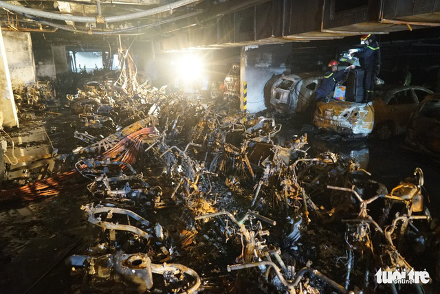 Motorbikes kept in the parking basement were burned down after the fire. Photo: Tuoi Tre