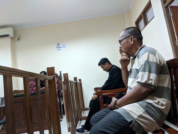 Luu Van Ly (front) sits inside a courtroom in Ranai, Indonesia March 29, 2018. Photo: Tuoi Tre
