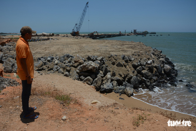 A man stands next to the port under construction of a company in Binh Thuan Province, Vietnam. Photo: Tuoi Tre
